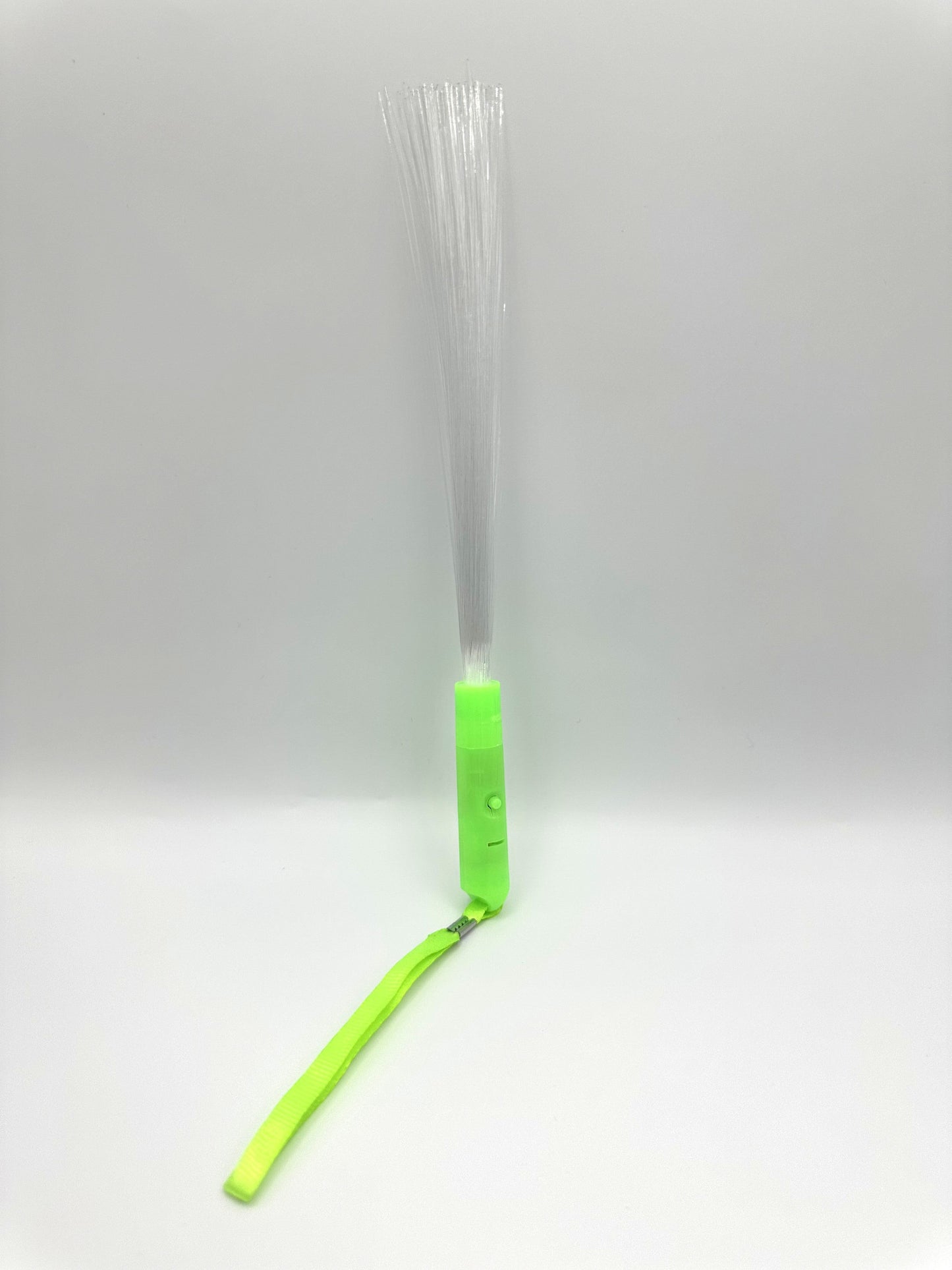 Sensitive Little Souls green LED flash fibre rod with transparent fibres and attached lanyard for sensory play.