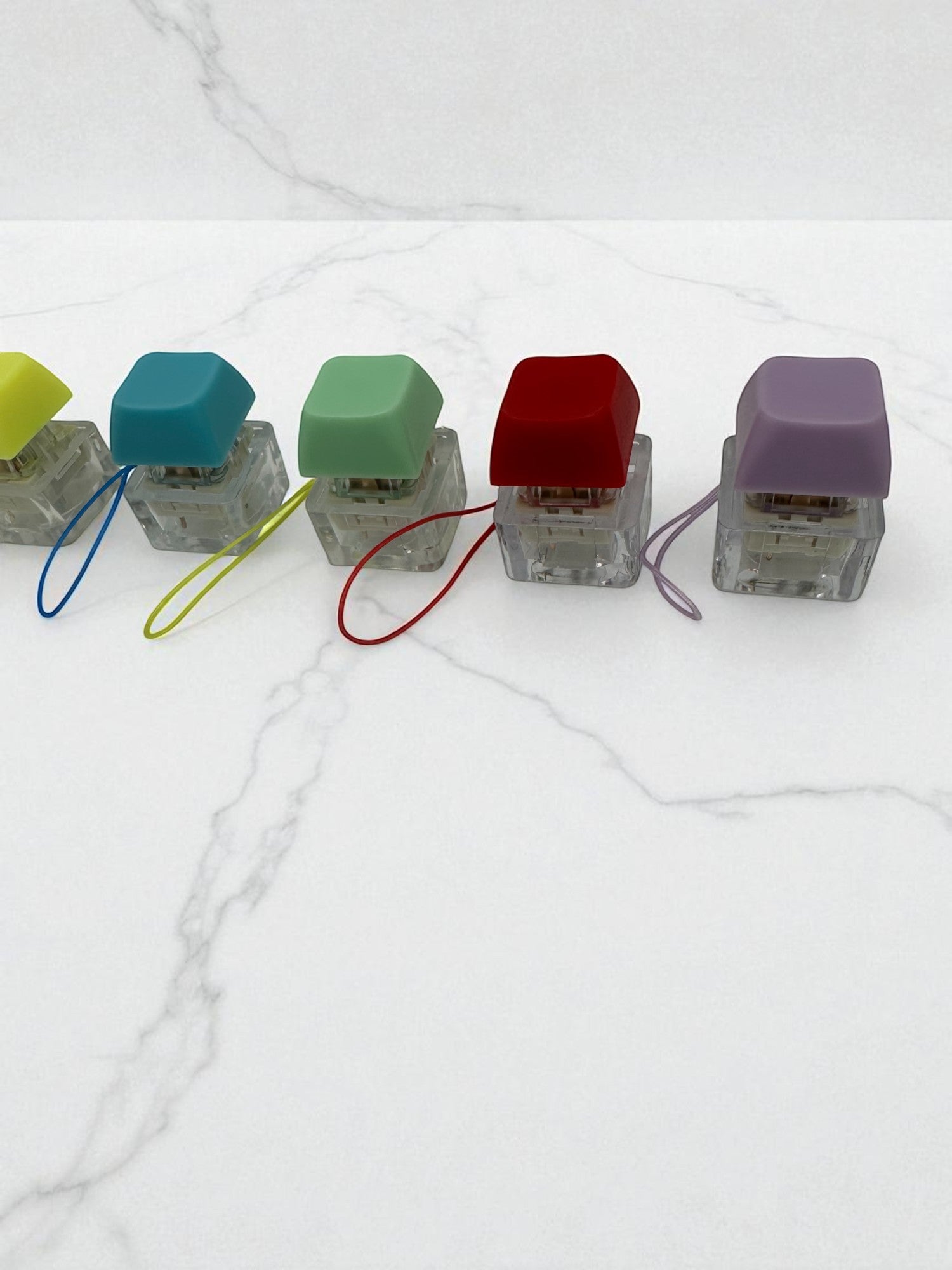 Sensitive Little Souls keyboard fidget clicker toy in yellow, teal, green, red, and purple with lanyards.