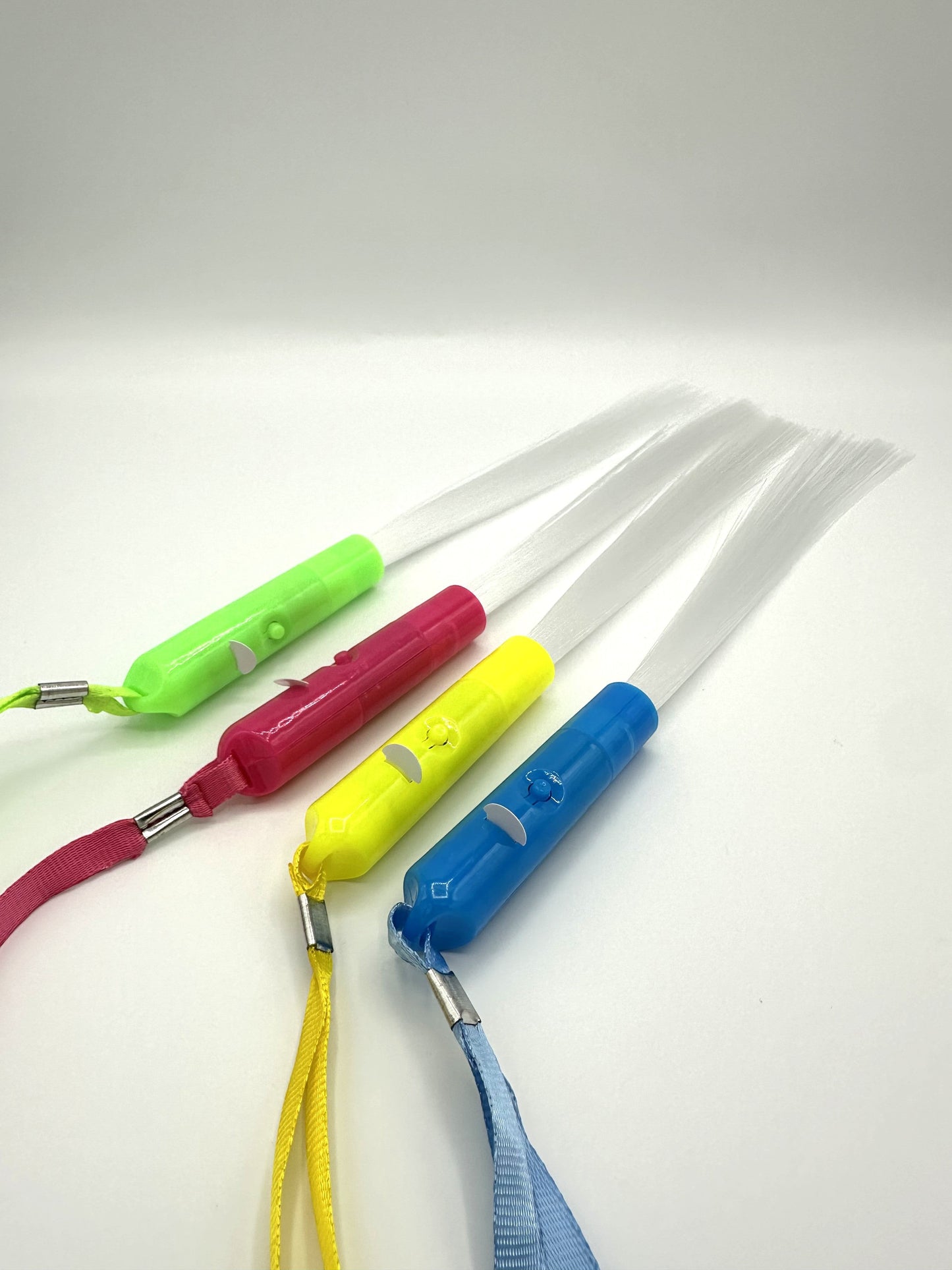 Sensitive Little Souls LED flash fibre rods in green, pink, yellow, and blue with white fibre strands and lanyards.