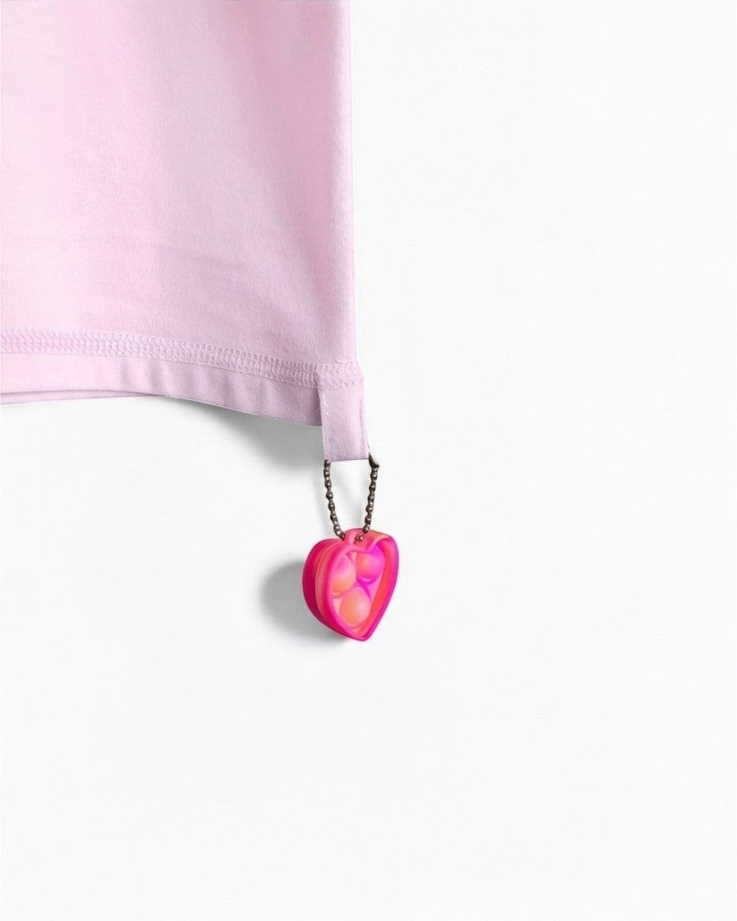 Sensitive Little Souls pink adaptive t-shirt with flat seams, tagless design, and a heart-shaped fidget loop.