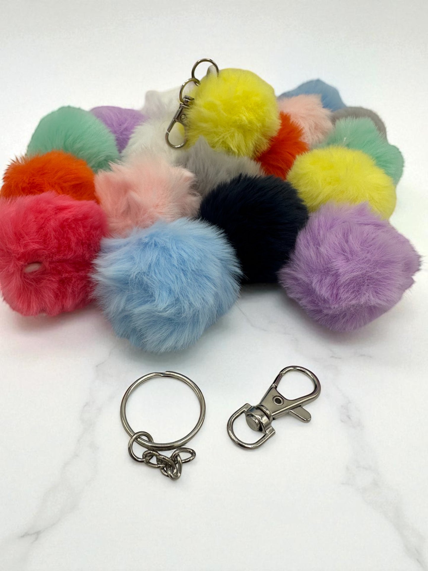 Sensitive Little Souls assorted color plush pom pom keychains with metal clasps and rings.