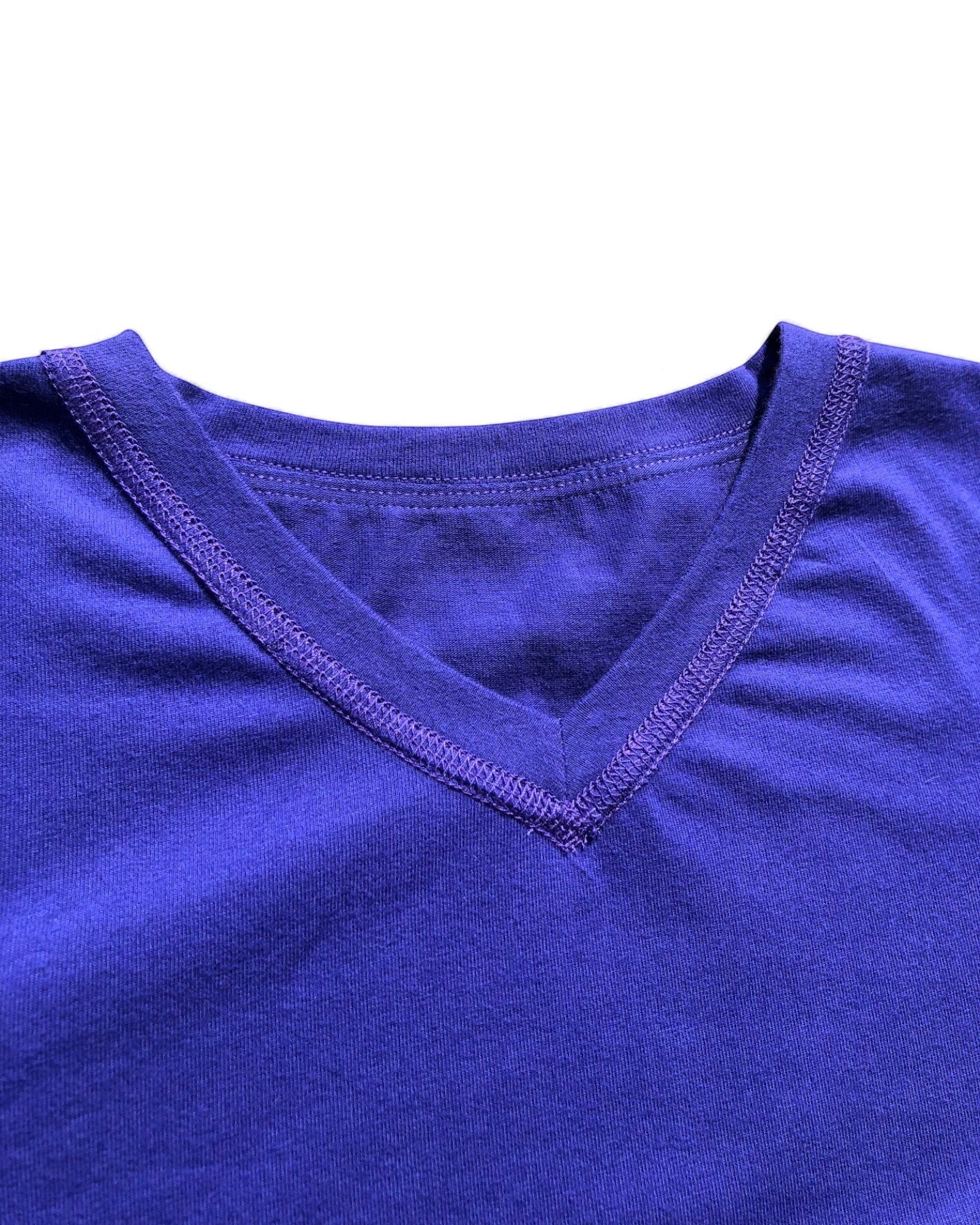 Sensitive Little Souls kids' purple short sleeve V-neck t-shirt with flat seams and fidget loop. Cotton blend.