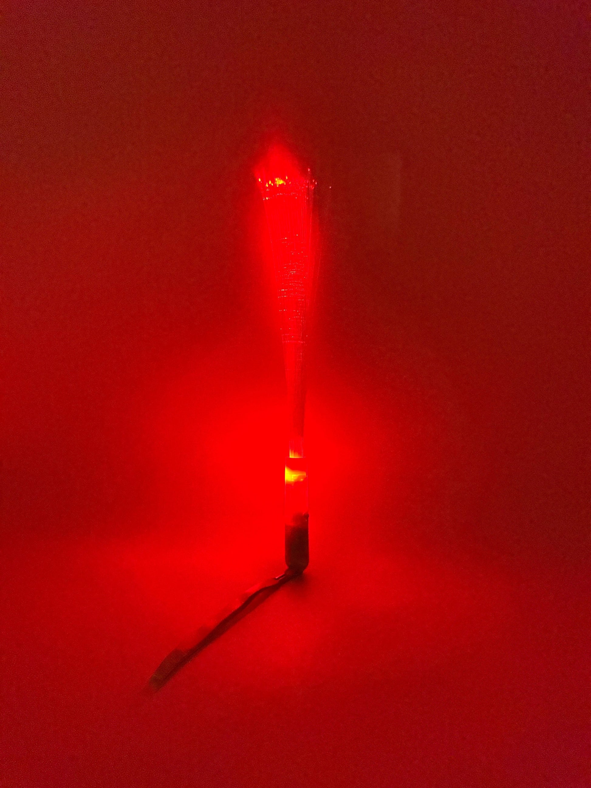 Sensitive Little Souls red LED flash fibre rod toy for sensory play, creating a mesmerizing light display.
