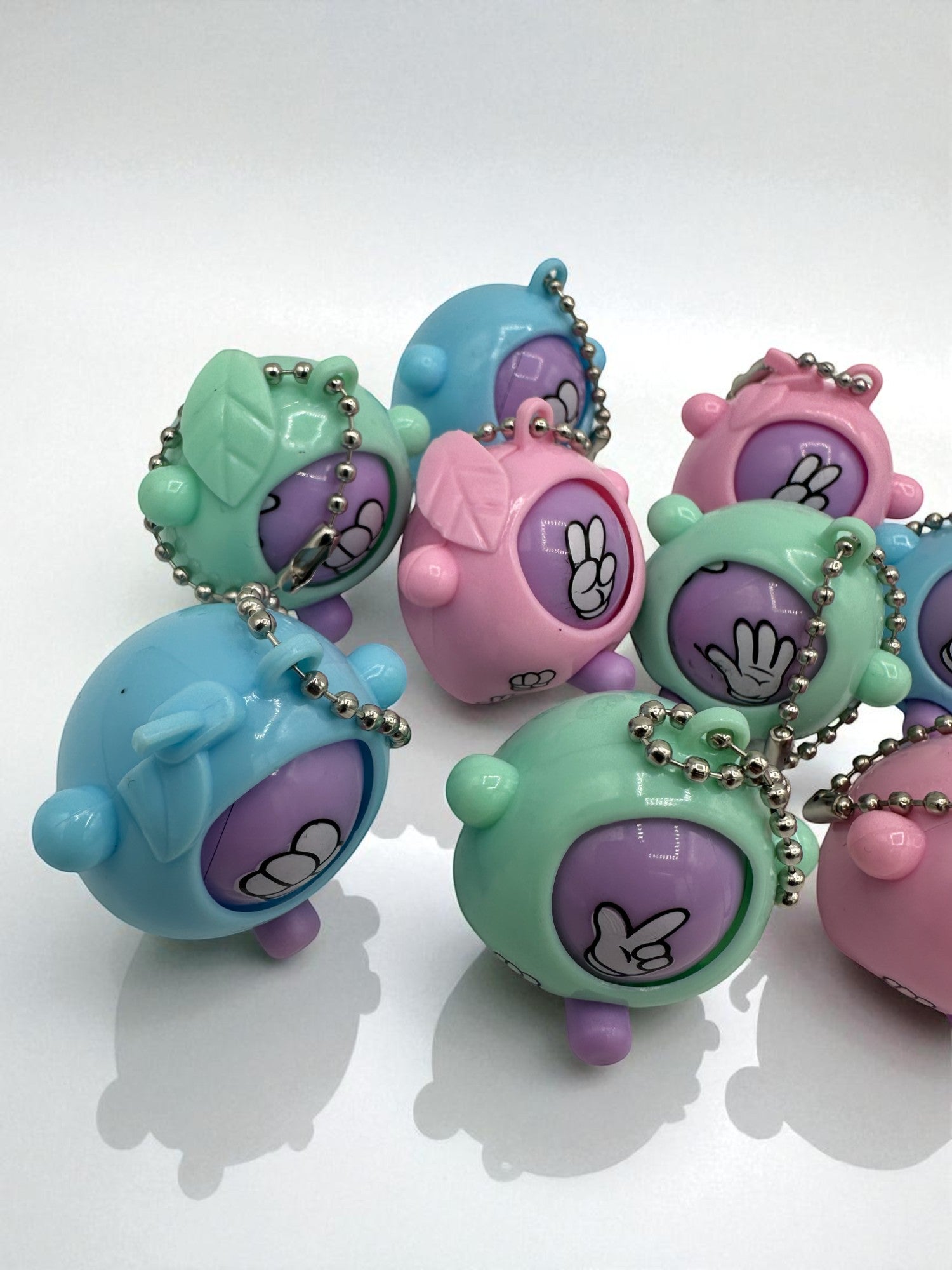 Sensitive Little Souls pastel Rock-Paper-Scissors game sensory toy with keychain. Features hand gestures in pink, blue, and green.