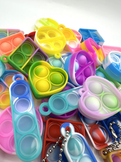 Sensitive Little Souls vibrant silicone bubble popping fidget toys in heart, square, and oval shapes. Assorted bright colors.