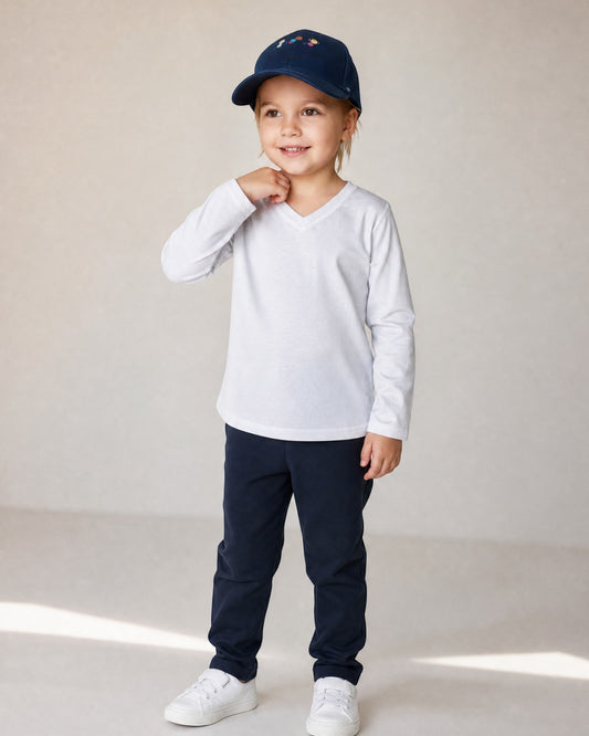 Sensitive Little Souls white long sleeve t-shirt with V-neck and fidget loop, worn by a child.