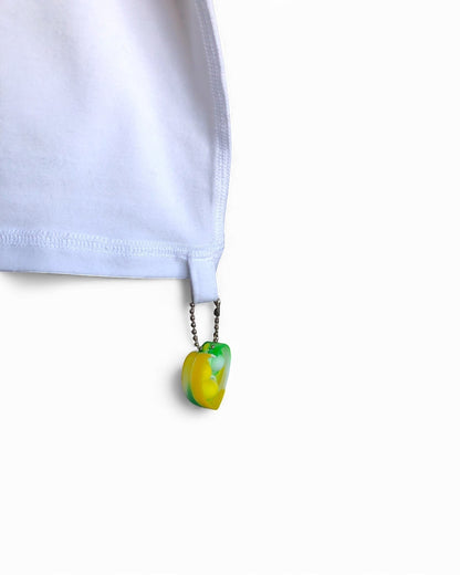 Sensitive Little Souls white adaptive t-shirt with flat seams and a green and yellow fidget loop on the hem.