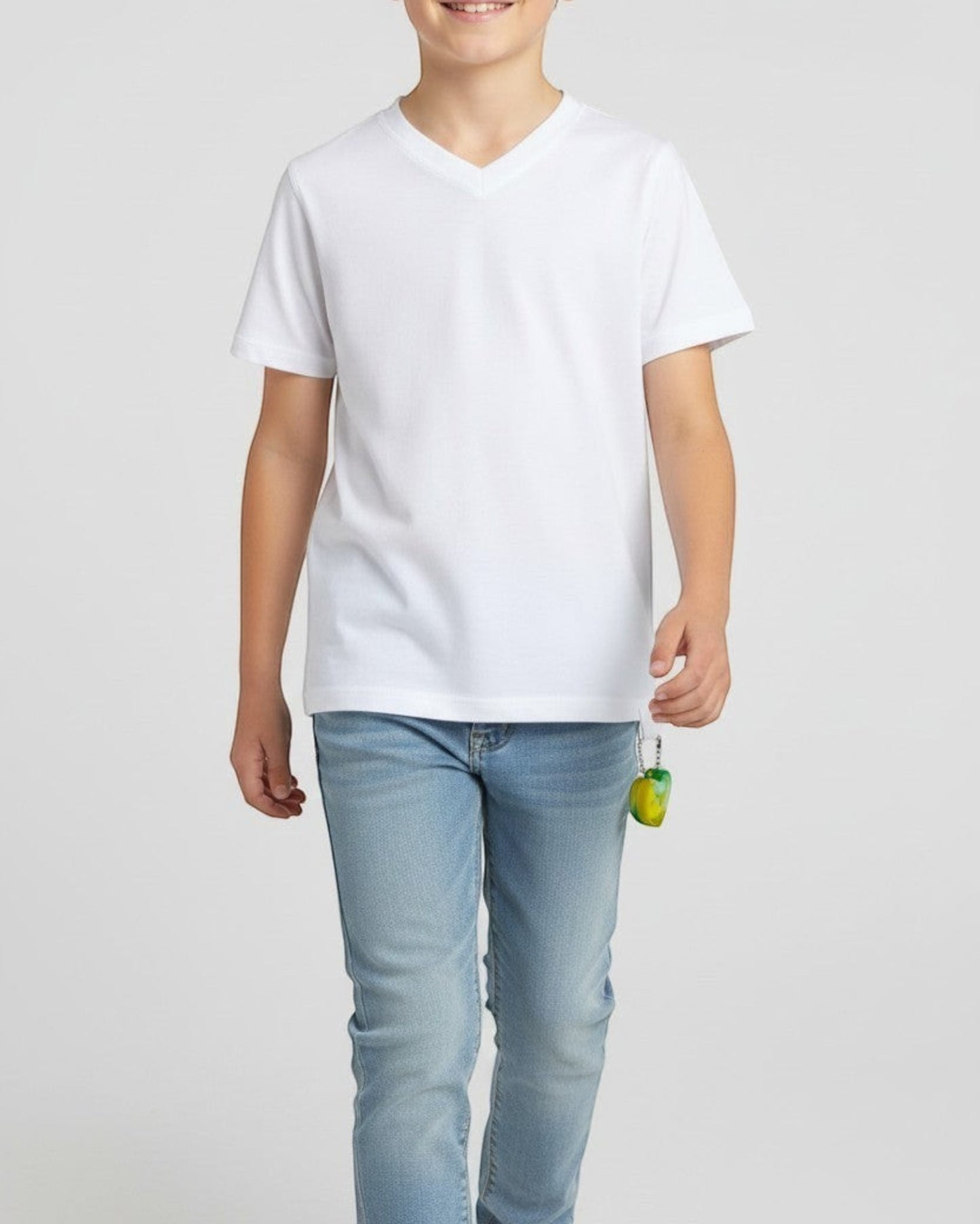 Sensitive Little Souls white adaptive t-shirt with flat seams and a discreet loop holding a green and yellow fidget toy.