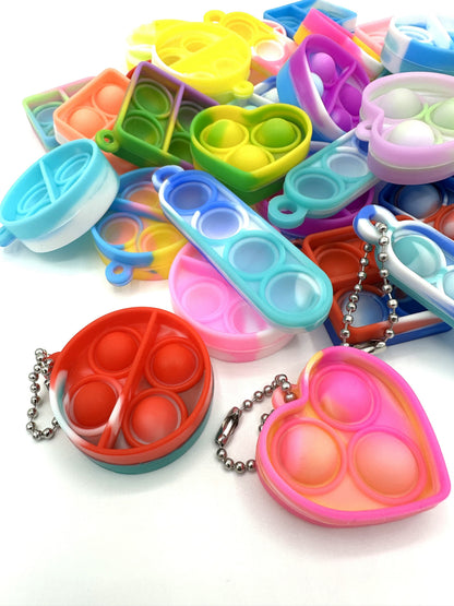 Sensitive Little Souls vibrant silicone bubble popping fidget toys in heart, square, and round shapes with keychain attachments.
