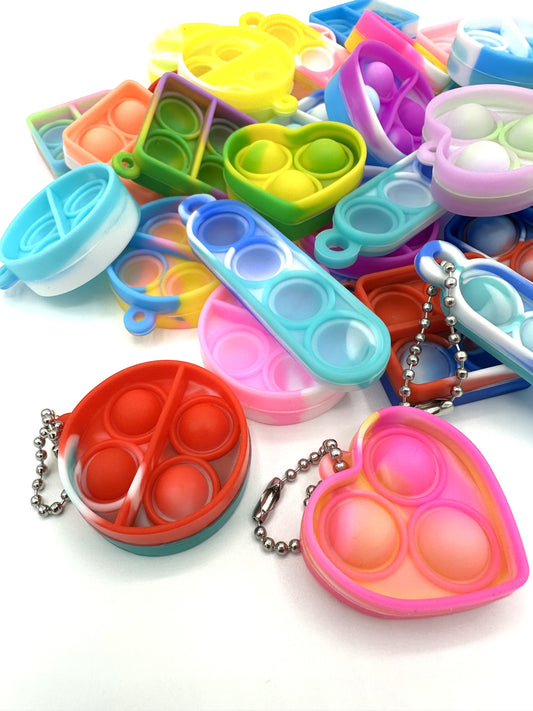 Sensitive Little Souls vibrant silicone bubble popping fidget toys in heart, square, and round shapes with keychain attachments.